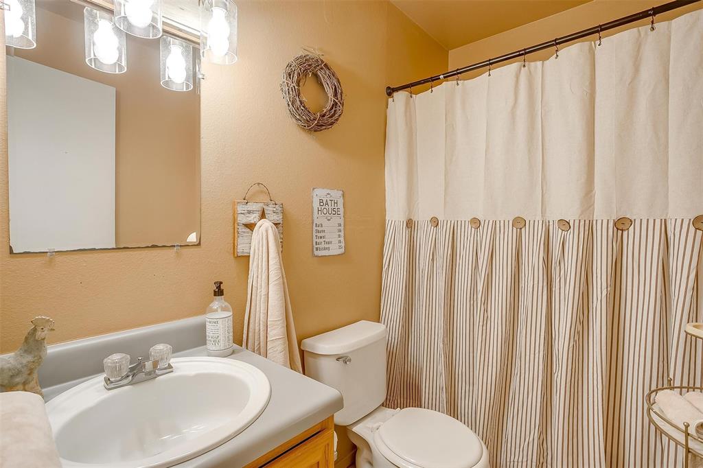 8716 County Road 1224A Rio Vista, TX 76093 - Photo 25 of 38 Full bathroom with vanity and a shower with curtain
