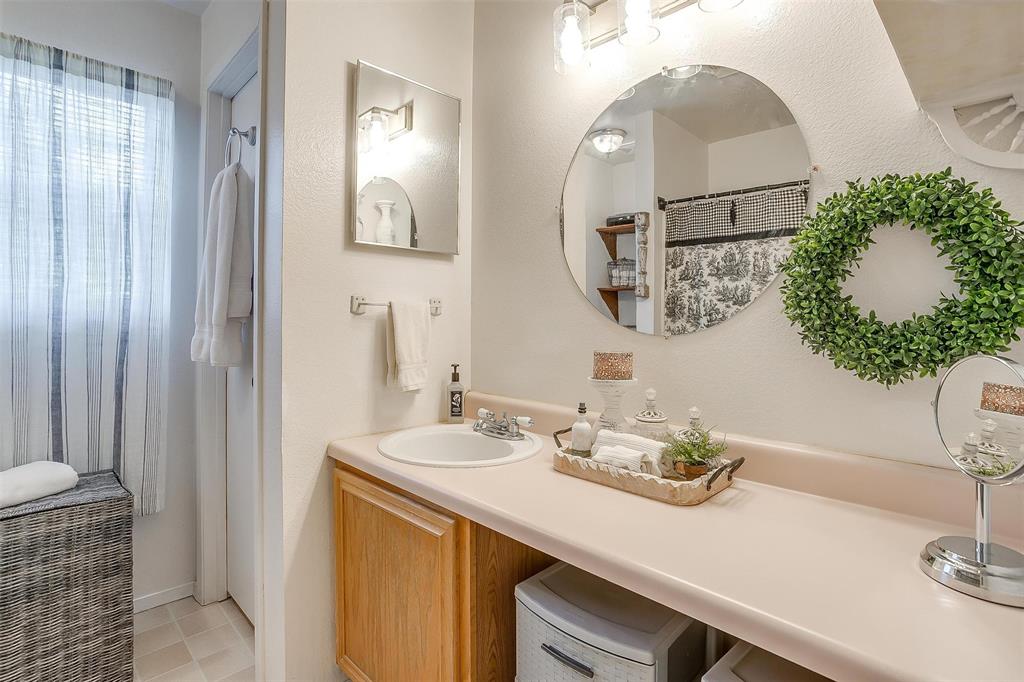 8716 County Road 1224A Rio Vista, TX 76093 - Photo 35 of 38 Bathroom with vanity, a shower with curtain, and light tile patterned floors