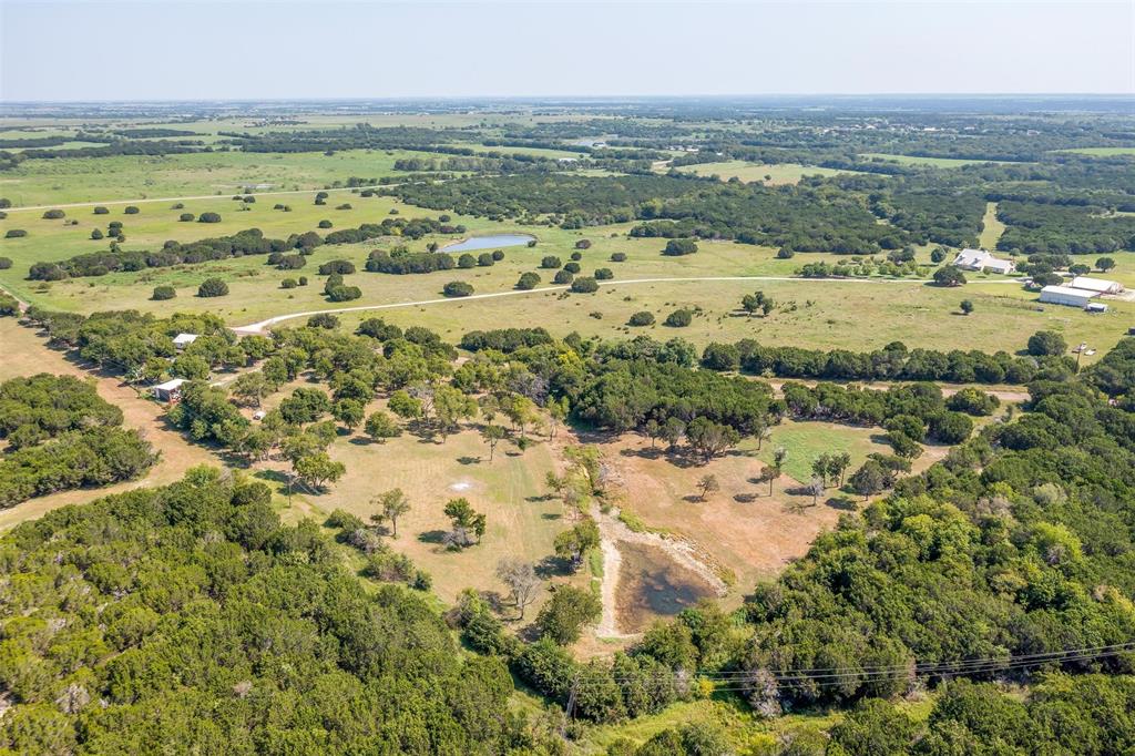 8716 County Road 1224A Rio Vista, TX 76093 - Photo 10 of 38 Aerial view of property and surrounding area featuring a forest