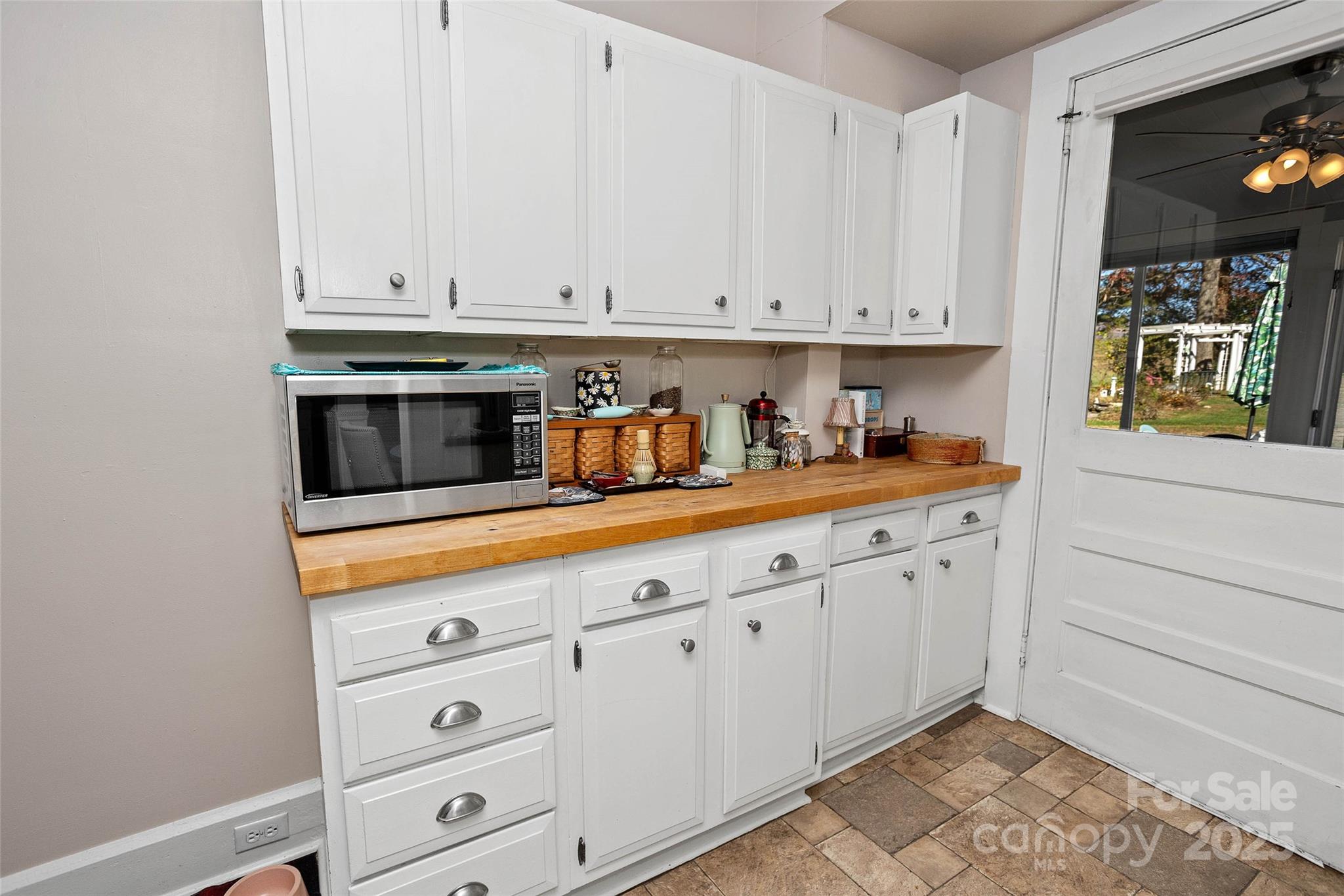 3471 Chimney Rock Road Hendersonville, NC 28792 - Photo 12 of 48 a kitchen with white cabinets and sink