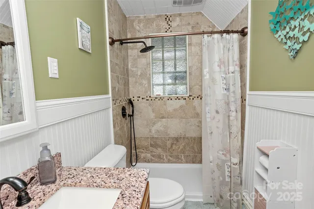 a bathroom with a sink toilet and shower