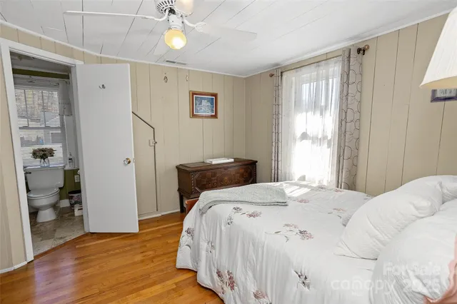 a bedroom with a bed and a desk