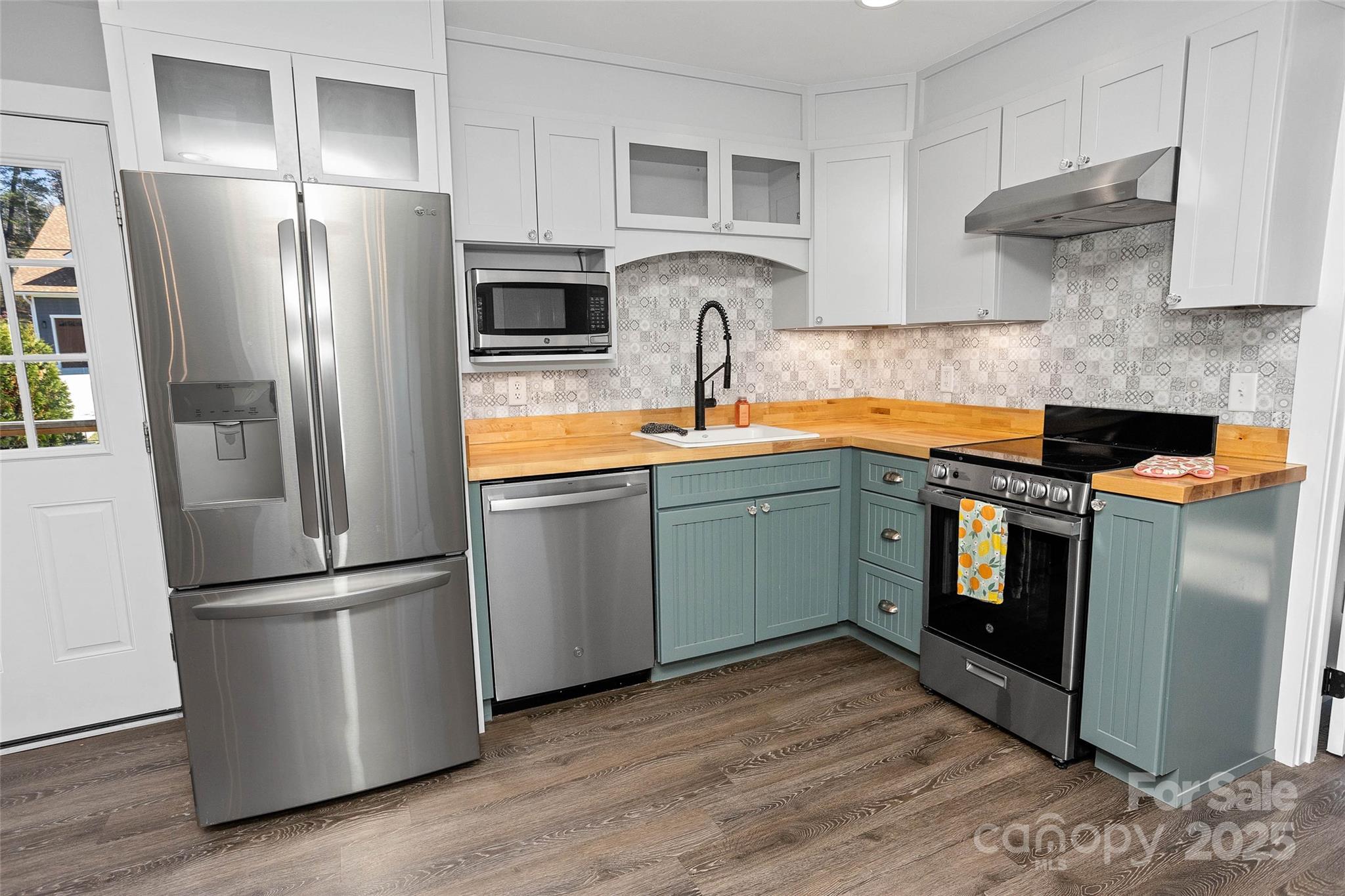 3471 Chimney Rock Road Hendersonville, NC 28792 - Photo 38 of 48 a kitchen with stainless steel appliances granite countertop a refrigerator stove and sink