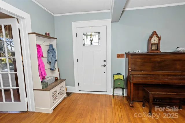 a view of a room with wooden floor and furniture