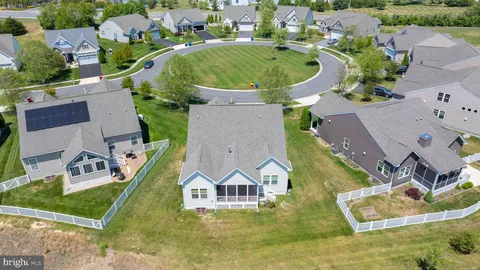 an aerial view of residential houses with outdoor space and swimming pool