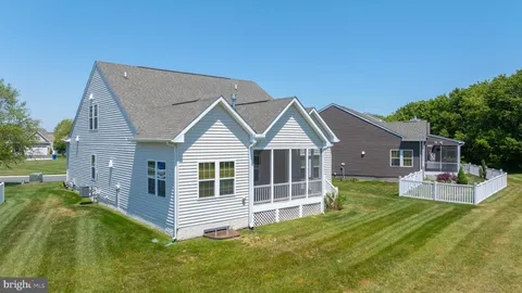 a view of a house with a yard and deck
