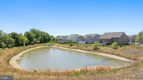 a view of a house with pool and a yard