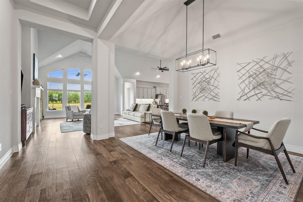 a view of a dining room with furniture wooden floor and chandelier