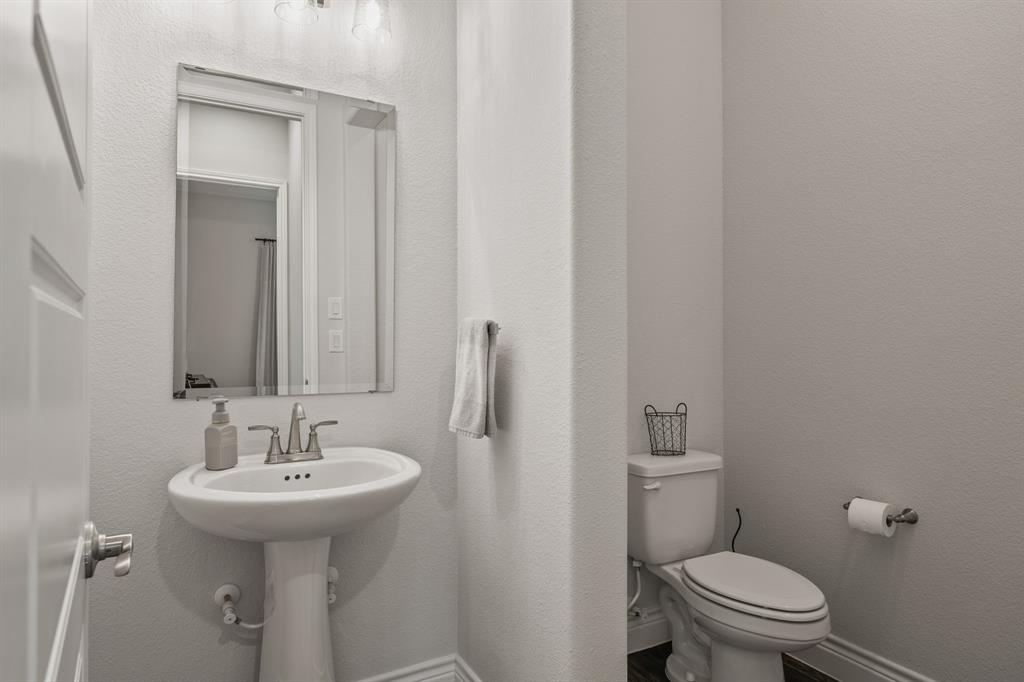 11504 Antler Ridge Way Argyle, TX 76226 - Photo 12 of 40 a bathroom with a sink toilet and a mirror