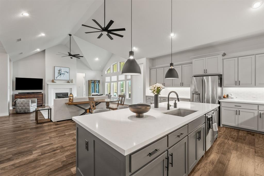 11504 Antler Ridge Way Argyle, TX 76226 - Photo 23 of 40 a kitchen with center island a sink appliances and cabinets