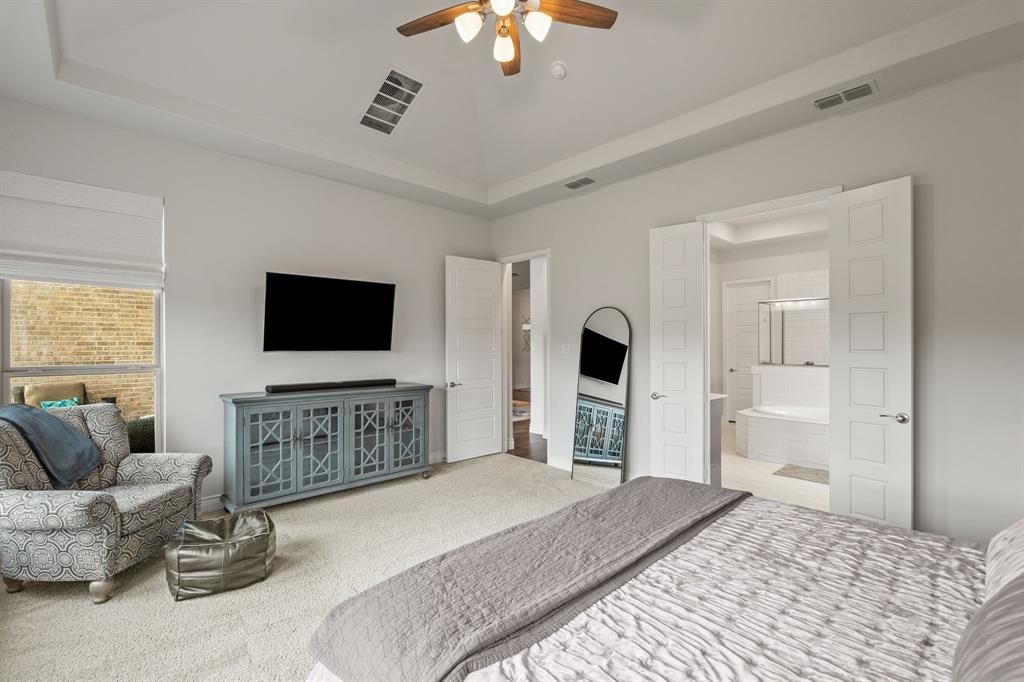 11504 Antler Ridge Way Argyle, TX 76226 - Photo 26 of 40 a bedroom with furniture and a flat screen tv