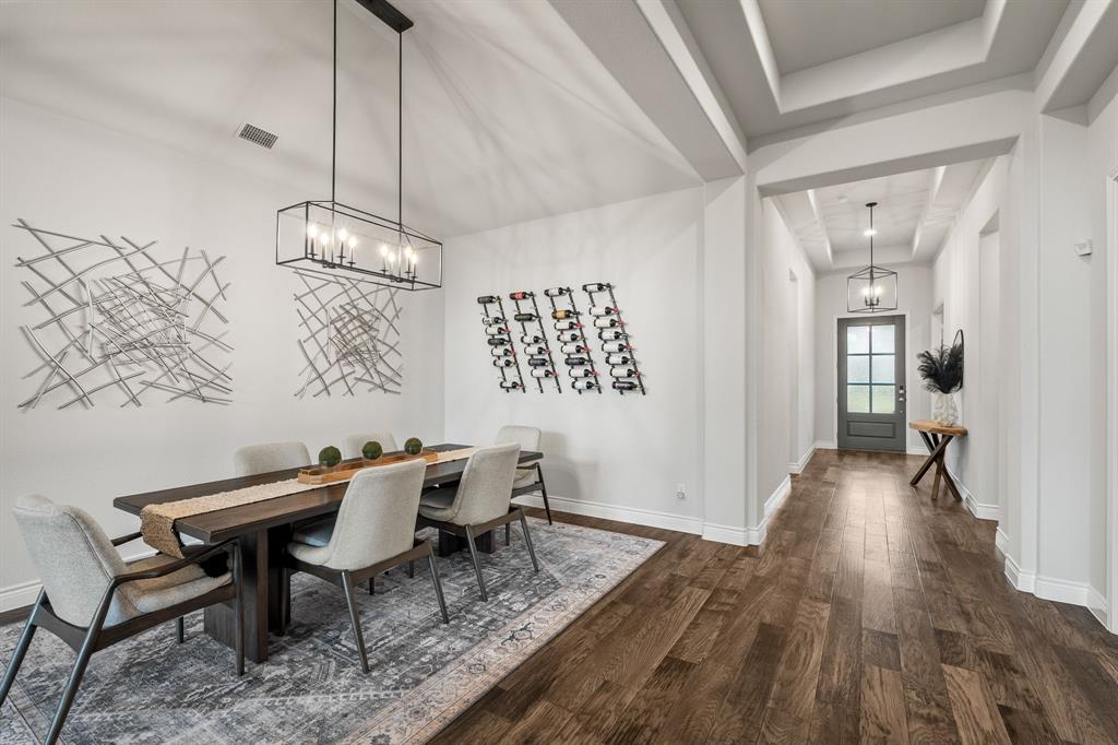 11504 Antler Ridge Way Argyle, TX 76226 - Photo 3 of 40 a view of a dining room with furniture wooden floor and a chandelier