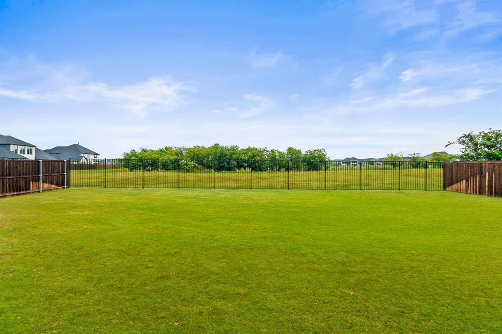 11504 Antler Ridge Way Argyle, TX 76226 - Photo 36 of 40 a view of a green field with wooden fence