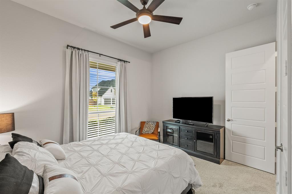 11504 Antler Ridge Way Argyle, TX 76226 - Photo 5 of 40 a bedroom with a bed and a flat screen tv