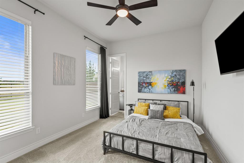 11504 Antler Ridge Way Argyle, TX 76226 - Photo 9 of 40 a bedroom with a bed and a flat screen tv