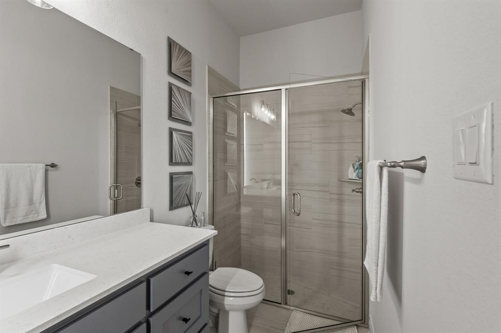 11504 Antler Ridge Way Argyle, TX 76226 - Photo 10 of 40 a bathroom with a granite countertop sink toilet and shower