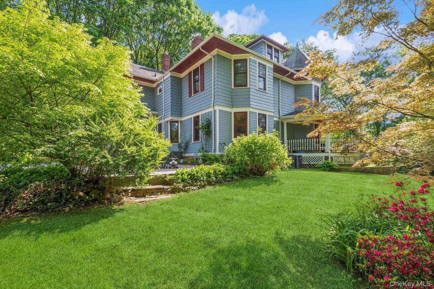 110 Red Spring Lane Glen Cove, NY 11542 - Photo 38 of 43 Lush green lawn with mature landscaping and flowering shrubs