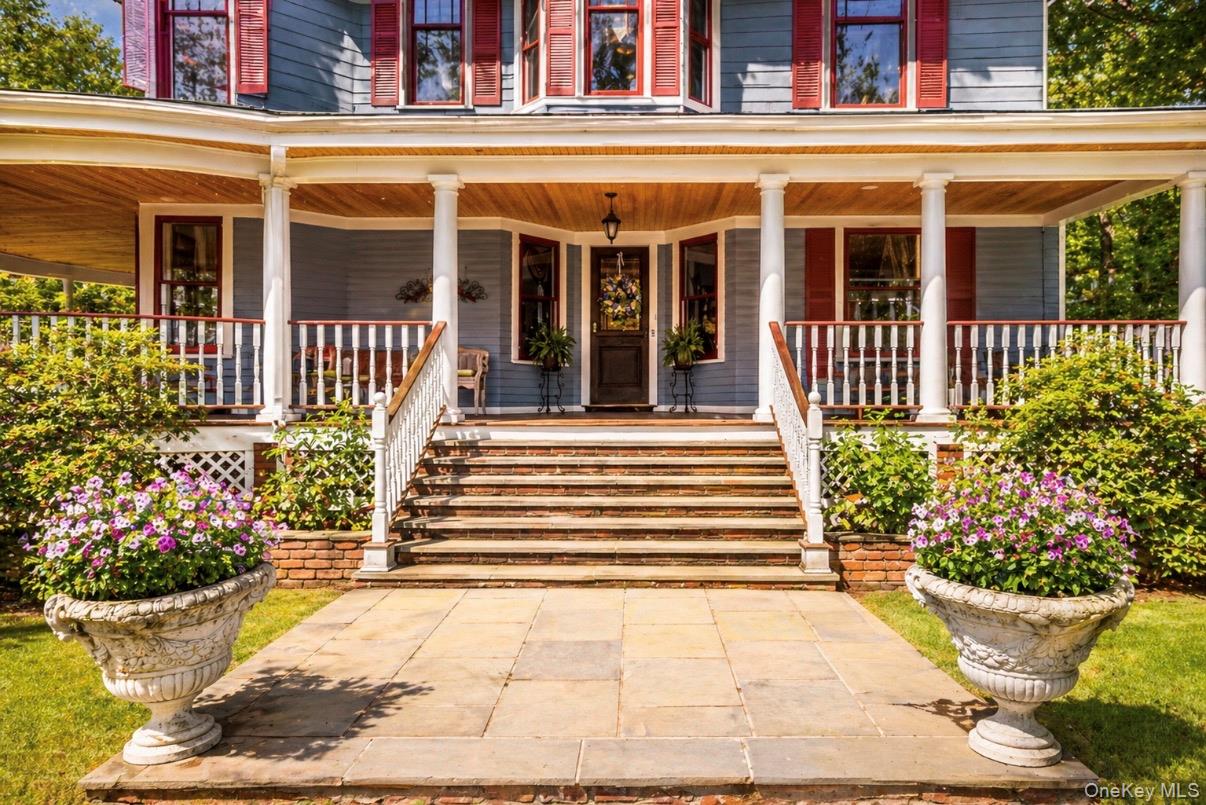 110 Red Spring Lane Glen Cove, NY 11542 - Photo 4 of 43 Doorway to property featuring wrap around porch