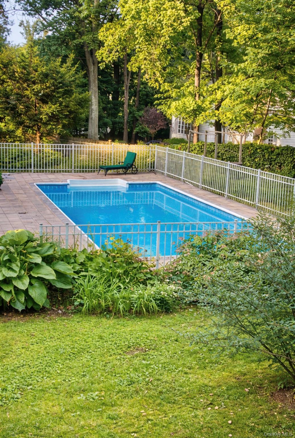 110 Red Spring Lane Glen Cove, NY 11542 - Photo 43 of 43 In-ground swimming pool with stone paver surround