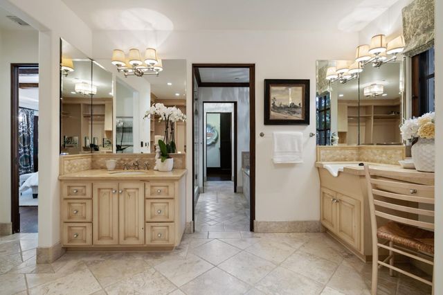 a bathroom with a tub shower and sink