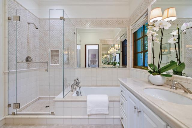 a large room with a large bed a flat screen tv