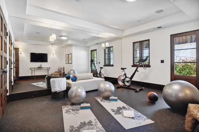 a view of a patio with table and chairs potted plants