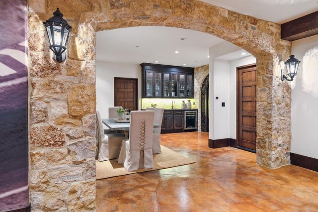 a view of a patio with table and chairs potted plants and palm tree