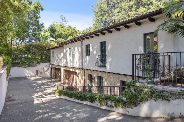 a living room with furniture a fireplace and a table