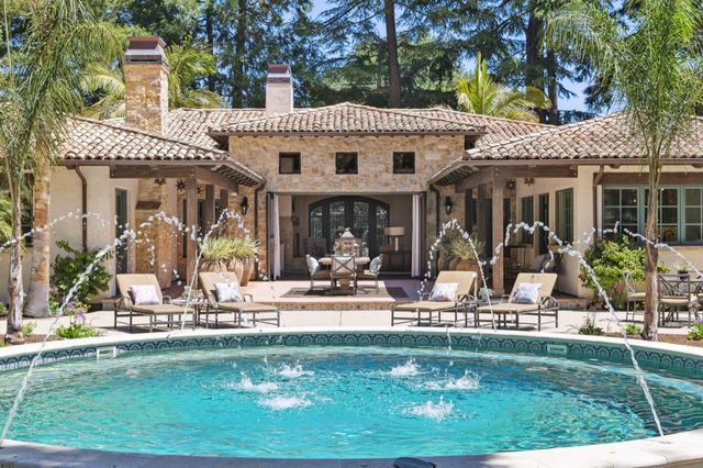 an aerial view of a house with a yard and fountain