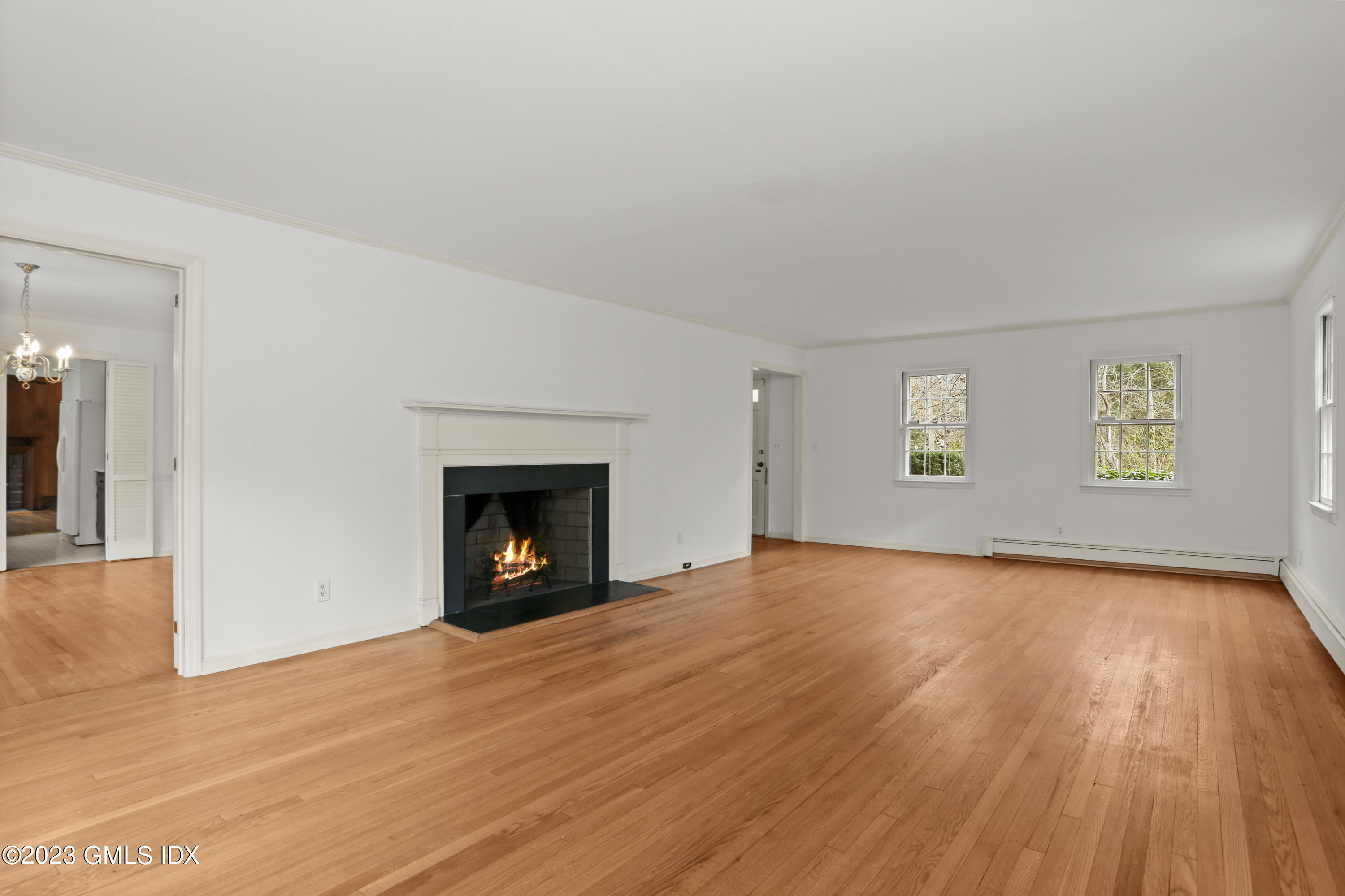 55 Frontier Road Cos Cob, CT 06807 - Photo 11 of 38 a view of an empty room with a window and a fireplace