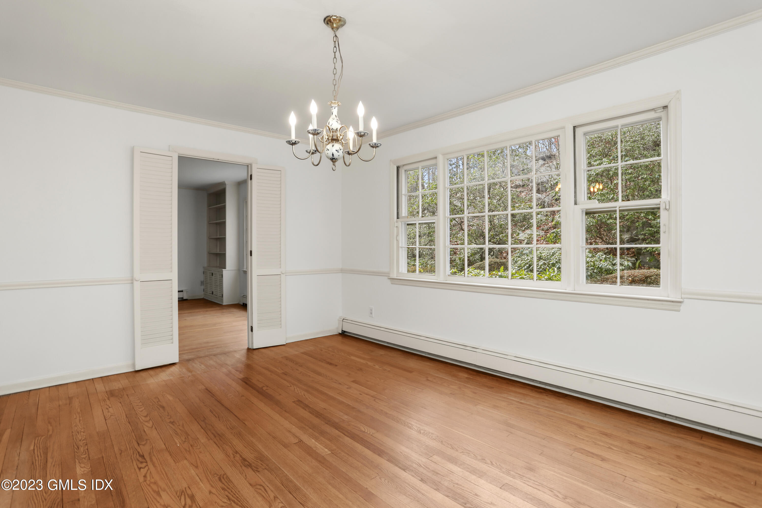 55 Frontier Road Cos Cob, CT 06807 - Photo 13 of 38 an empty room with wooden floor and windows