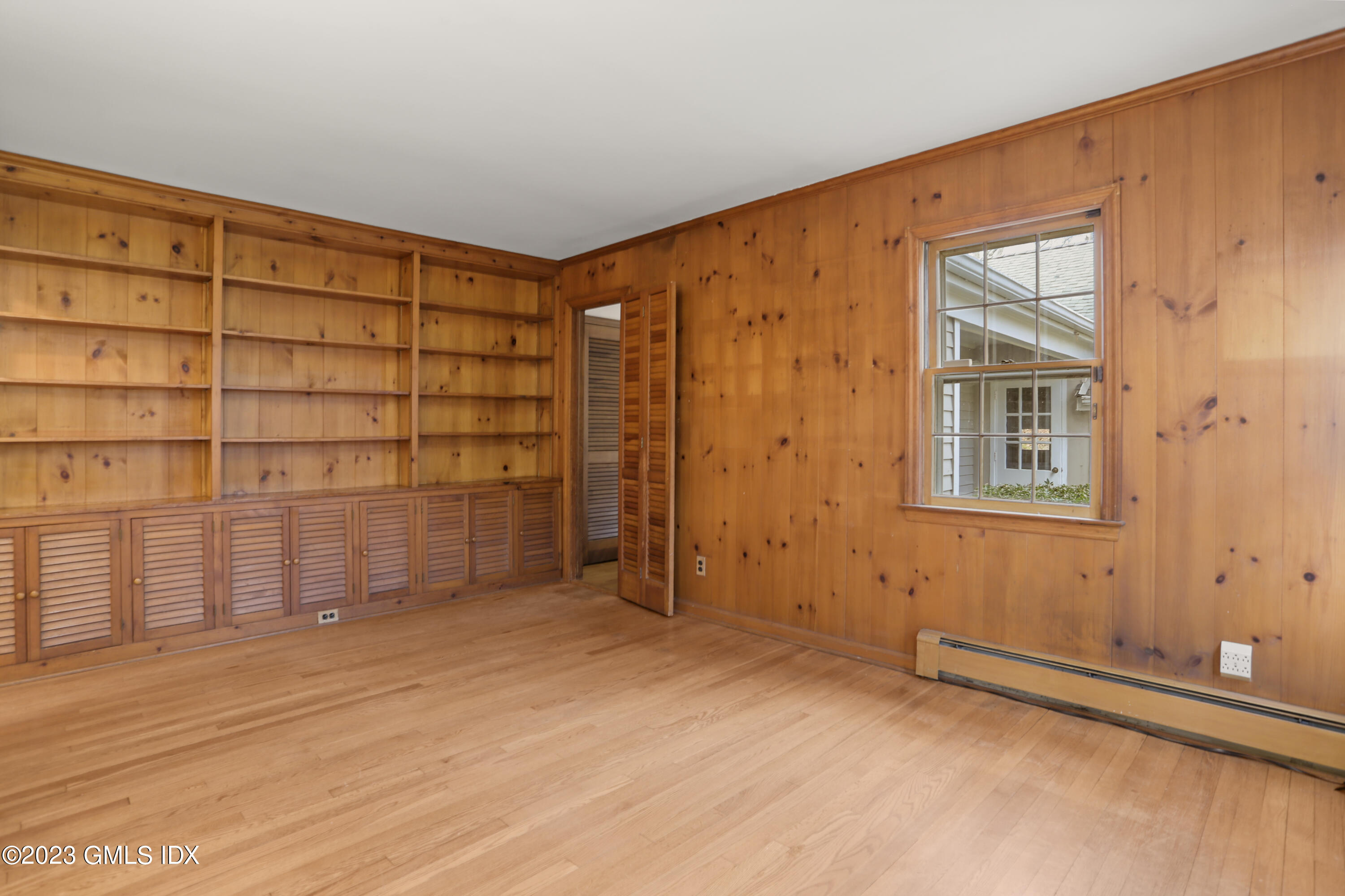 55 Frontier Road Cos Cob, CT 06807 - Photo 15 of 38 a view of an empty room with wooden floor and a window