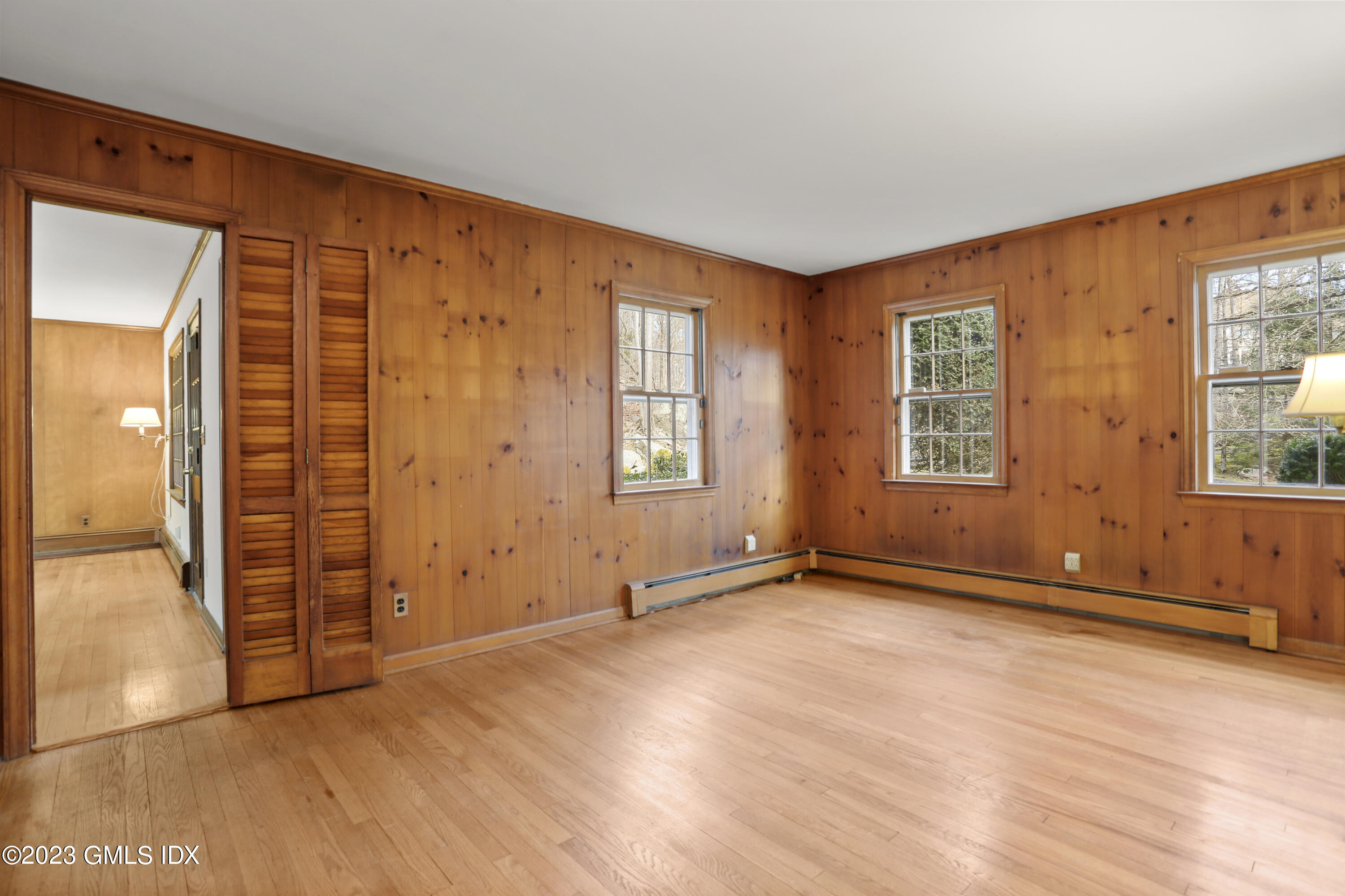 55 Frontier Road Cos Cob, CT 06807 - Photo 16 of 38 an empty room with wooden floor and windows