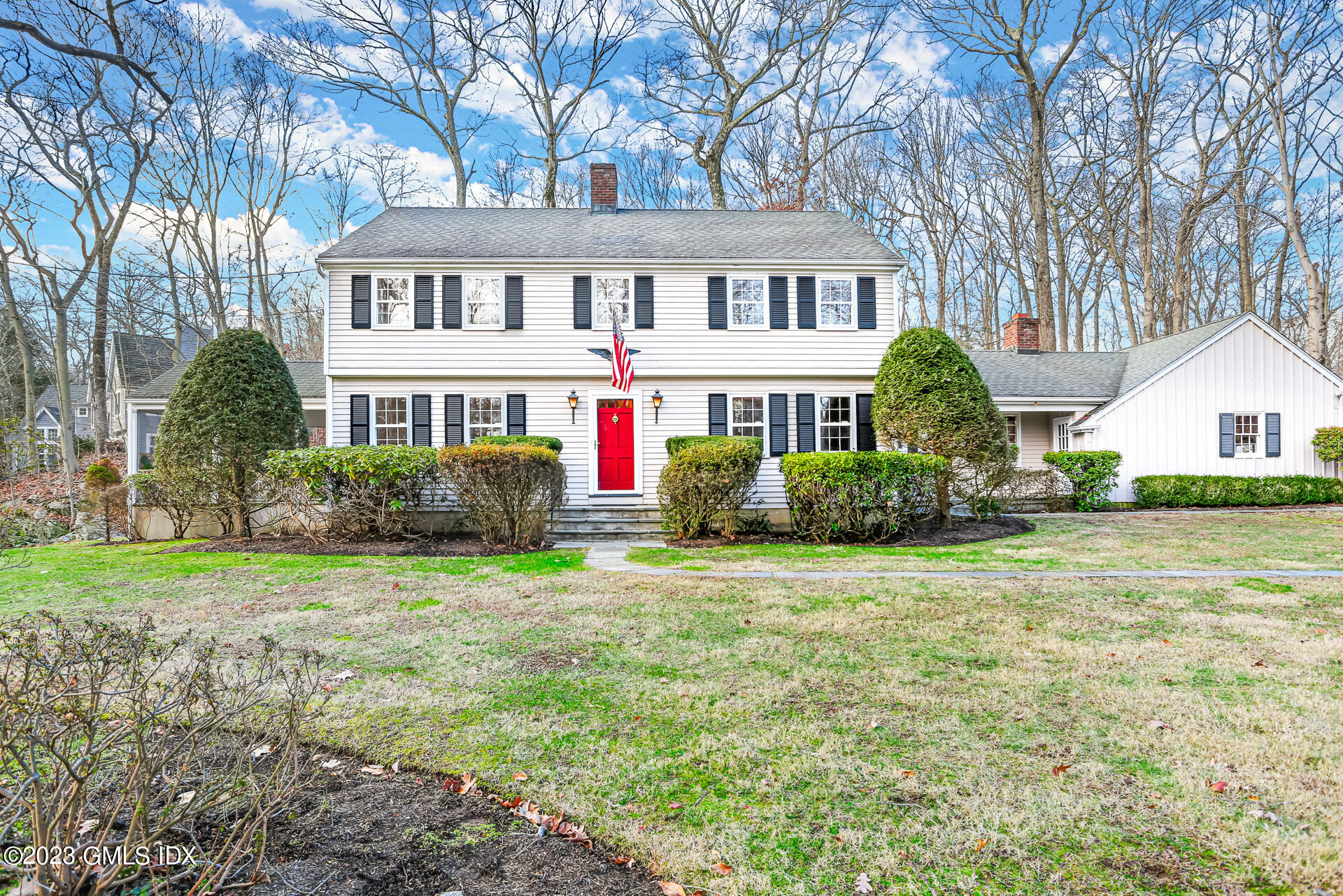 55 Frontier Road Cos Cob, CT 06807 - Photo 2 of 38 a front view of a house with a garden and trees