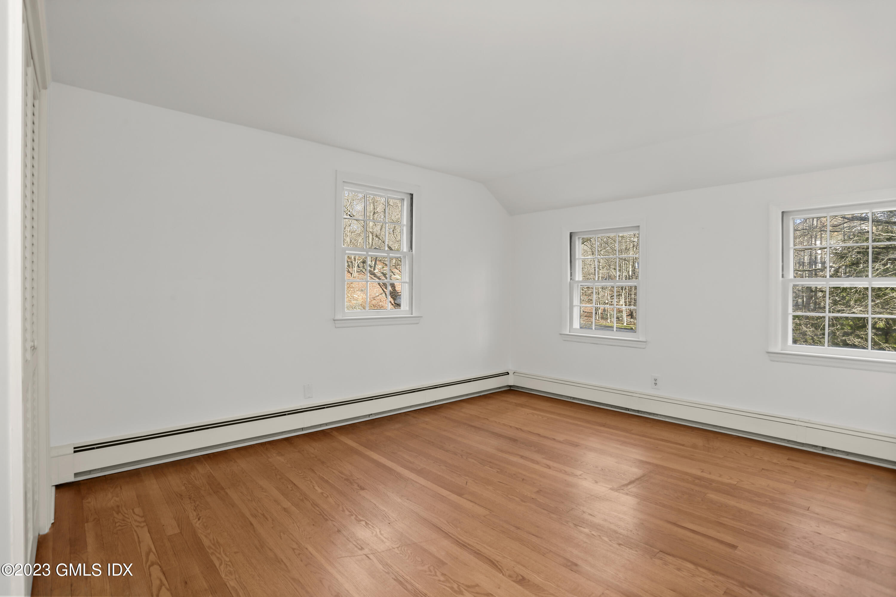 55 Frontier Road Cos Cob, CT 06807 - Photo 24 of 38 an empty room with wooden floor and windows