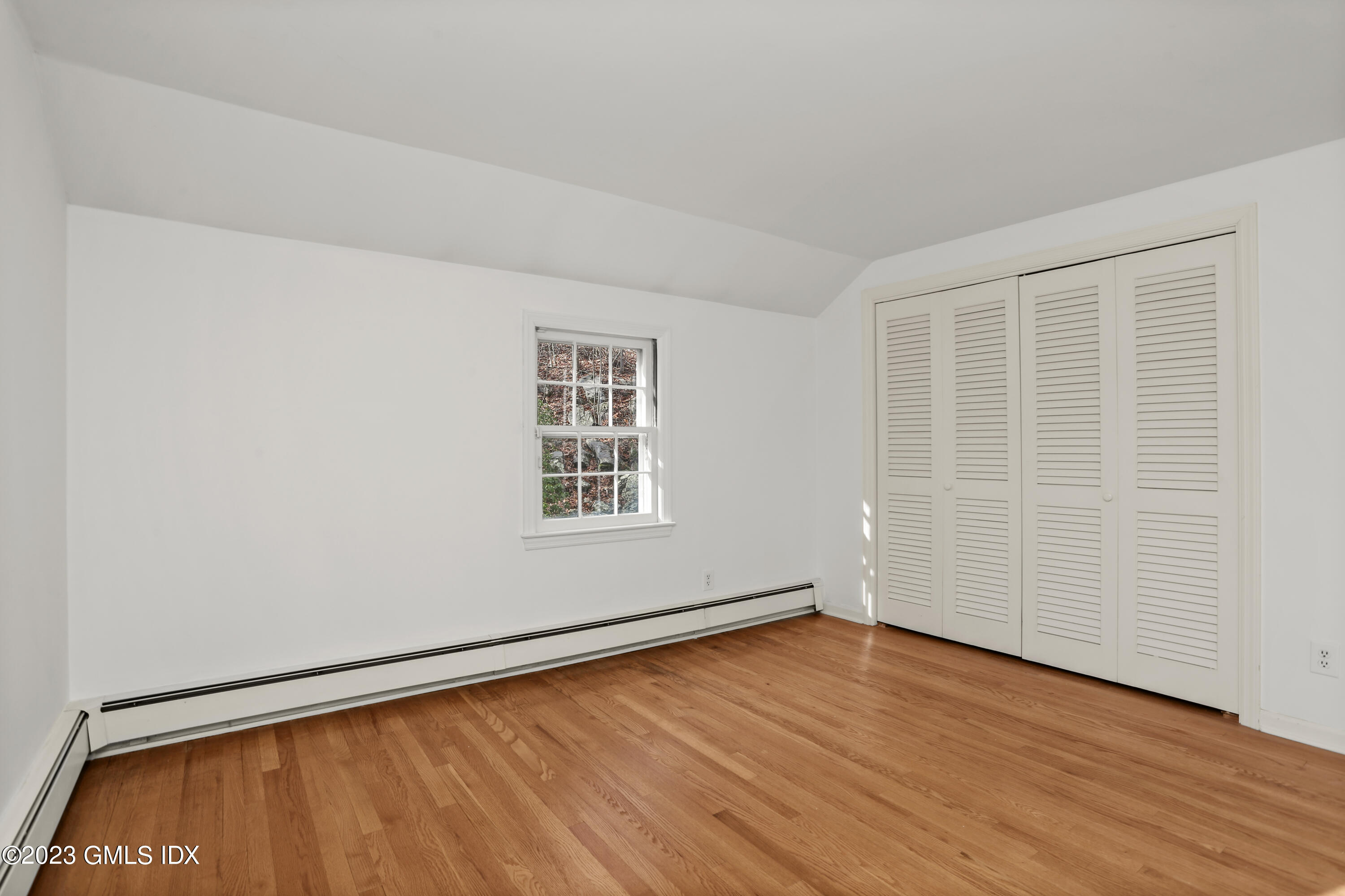 55 Frontier Road Cos Cob, CT 06807 - Photo 27 of 38 an empty room with wooden floor and windows