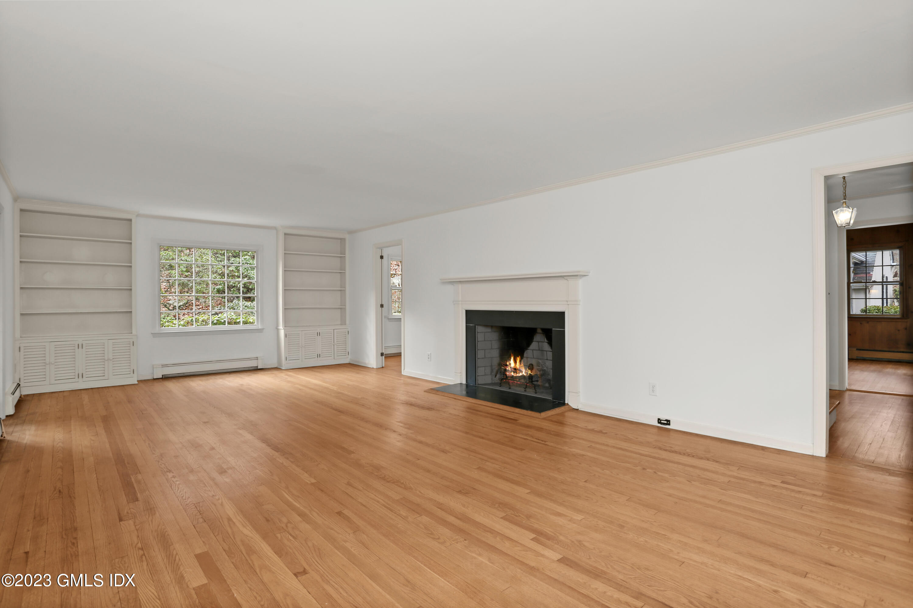 55 Frontier Road Cos Cob, CT 06807 - Photo 10 of 38 an empty room with windows and fireplace