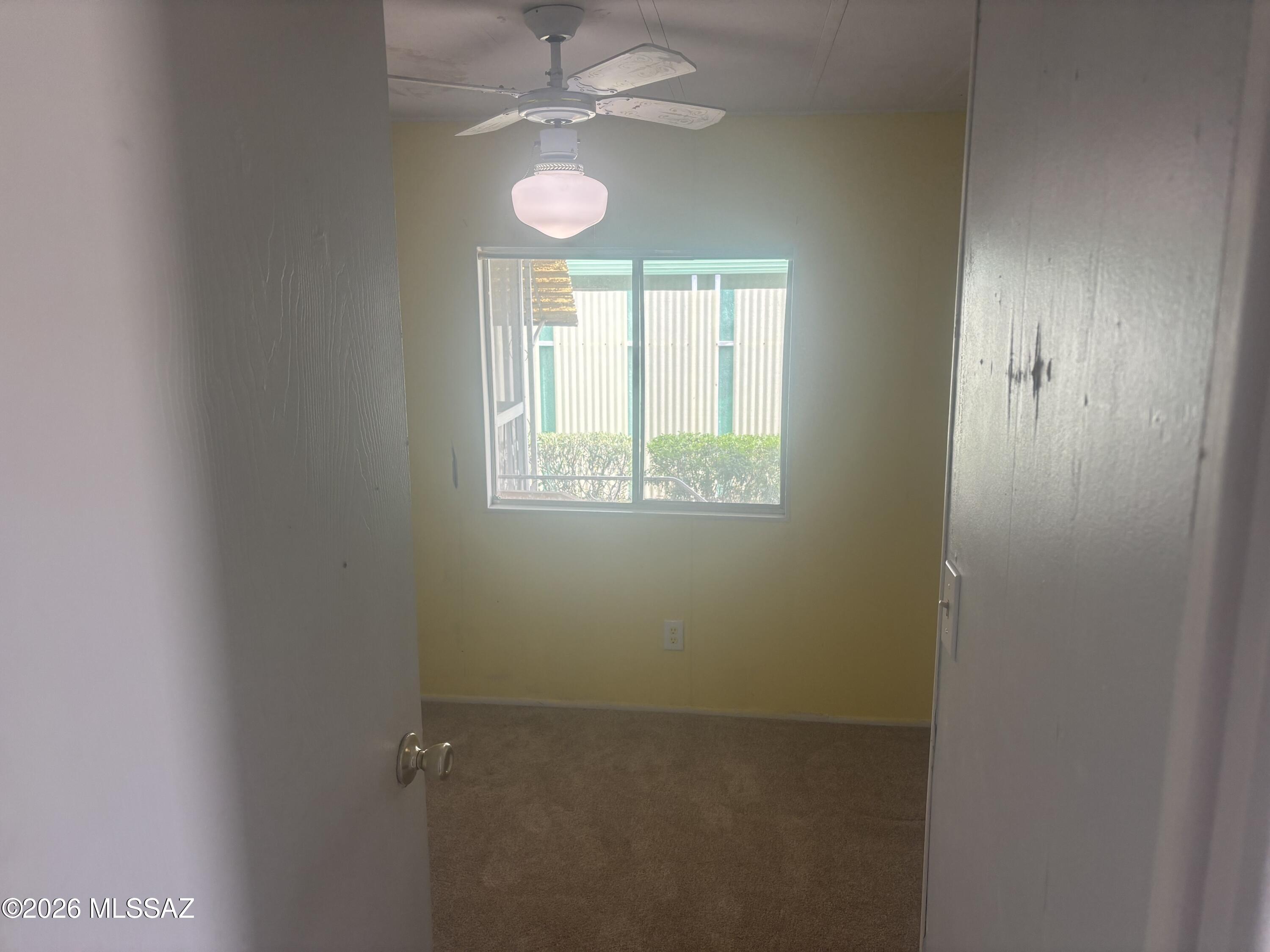 4550 North Flowing Wells Road, Unit 65 Tucson, AZ 85705 - Photo 26 of 50 an empty room with windows and fan