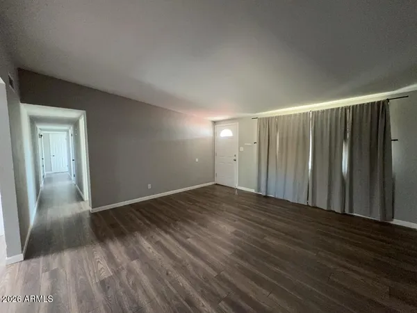 a kitchen with granite countertop a refrigerator stove top oven and sink