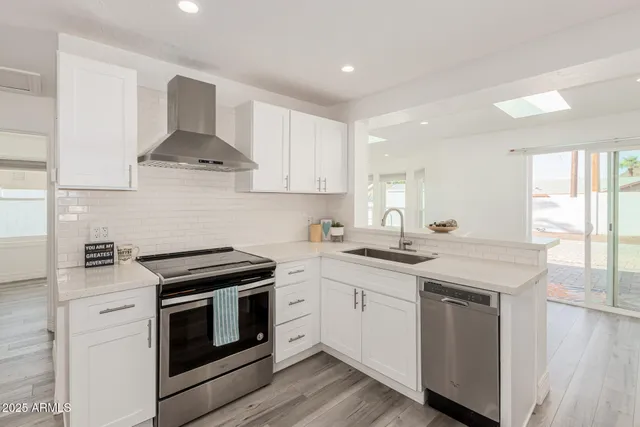 a kitchen with a sink a stove refrigerator and cabinets