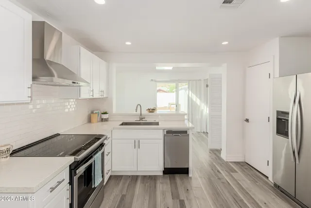 a kitchen with a sink stove and cabinets
