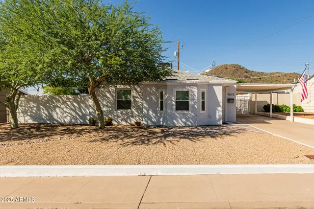 a front view of a house with a road