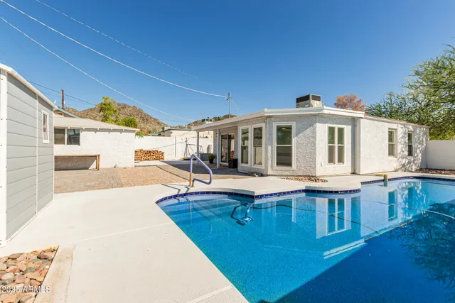 a view of a swimming pool with a lounge chair