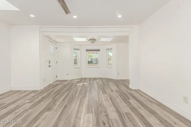 a view of a kitchen with a dishwasher and wooden floor