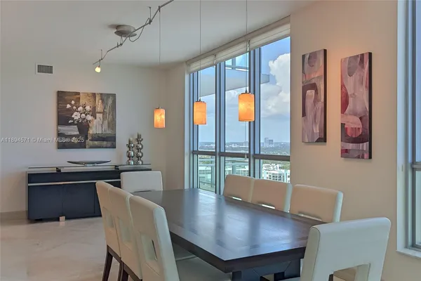 a living room with furniture flat screen tv and a large window