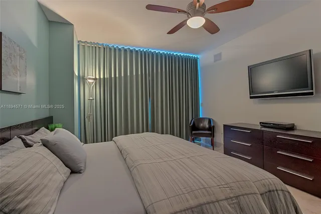 a living room with furniture a fireplace and a chandelier