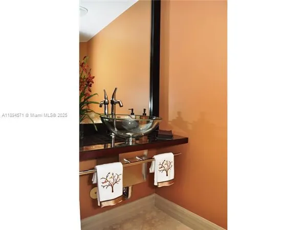 a large kitchen with stainless steel appliances kitchen island a stove a sink a refrigerator and a cabinets