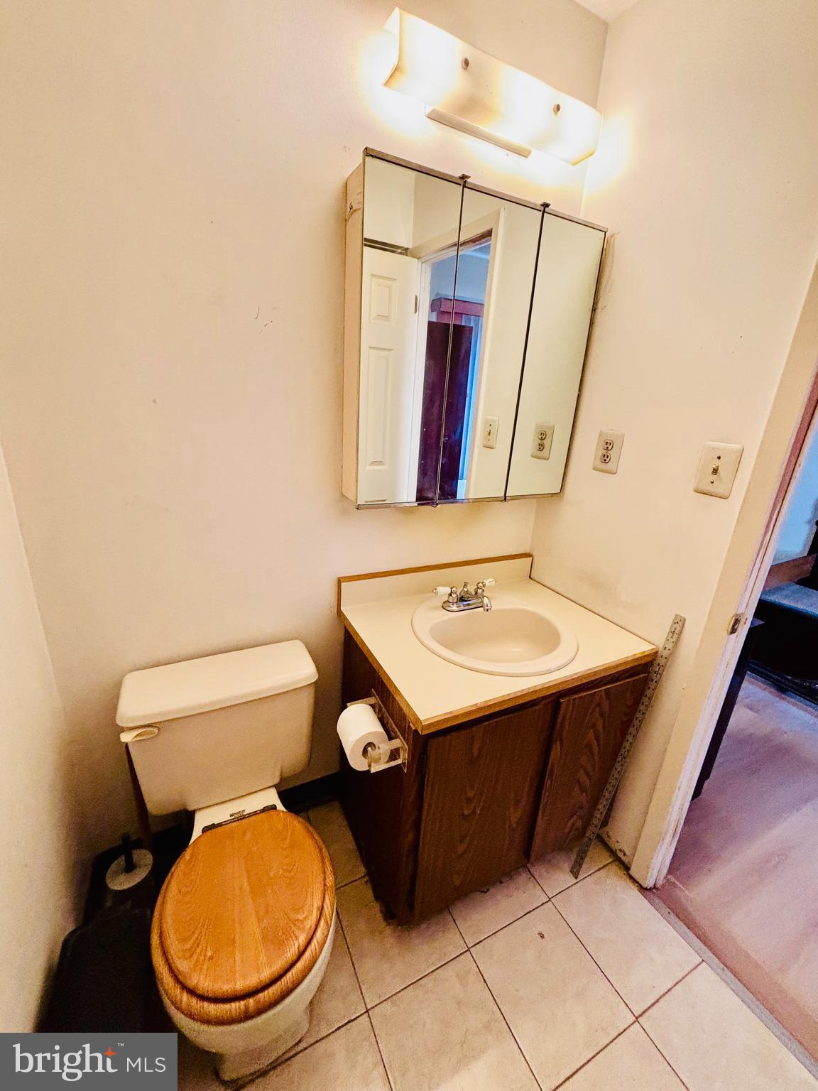 9336 Neil Road, Unit B Philadelphia, PA 19115 - Photo 17 of 37 a bathroom with a toilet a sink and mirror