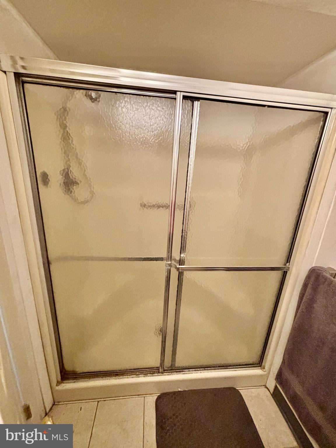 9336 Neil Road, Unit B Philadelphia, PA 19115 - Photo 18 of 37 a bathroom with a glass shower door