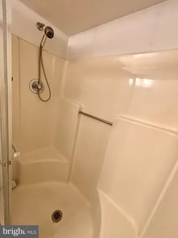 a bathroom with a glass shower door